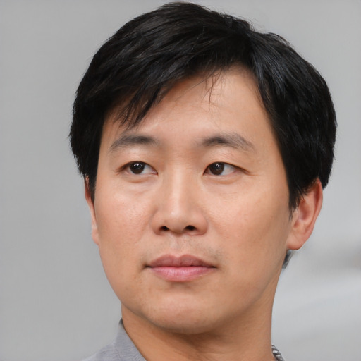 Neutral asian adult male with short  black hair and brown eyes