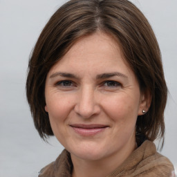 Joyful white adult female with medium  brown hair and brown eyes