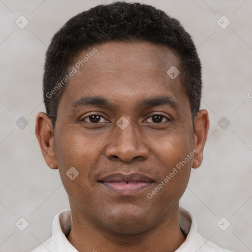 Joyful latino young-adult male with short  brown hair and brown eyes