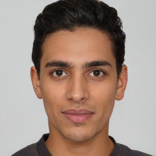 Joyful latino young-adult male with short  black hair and brown eyes