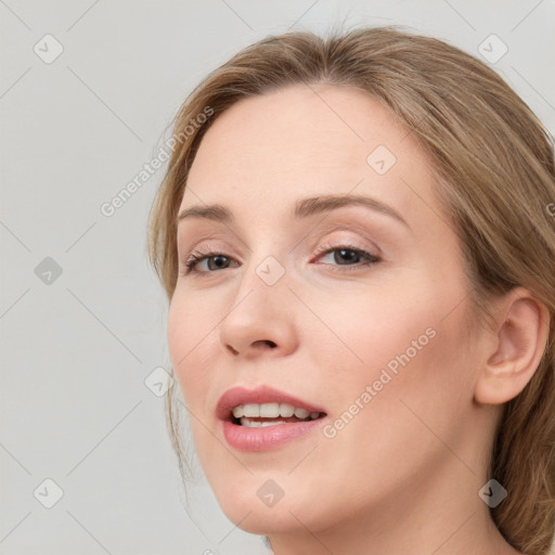 Joyful white young-adult female with long  brown hair and blue eyes