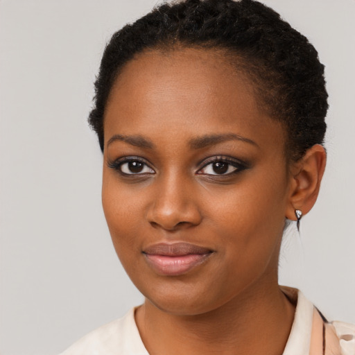 Joyful black young-adult female with short  brown hair and brown eyes