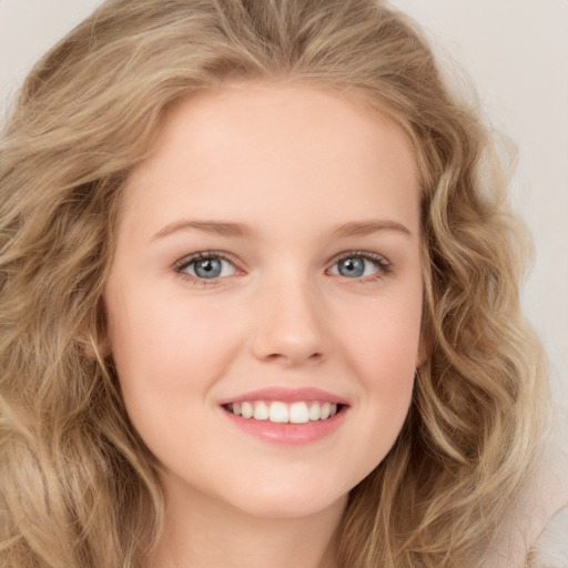 Joyful white young-adult female with long  brown hair and green eyes