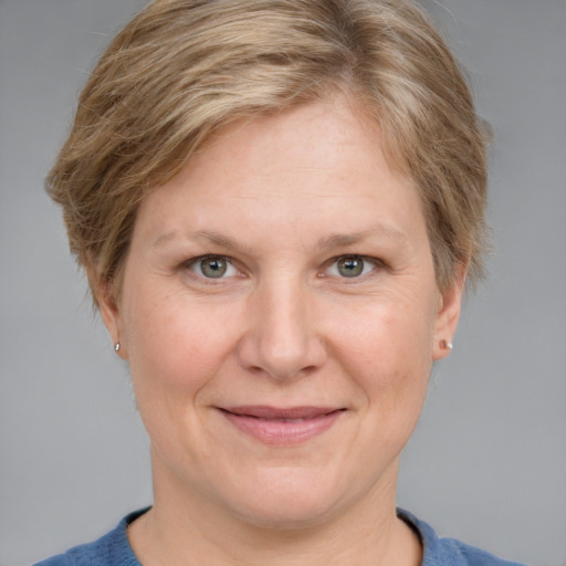 Joyful white adult female with short  brown hair and grey eyes