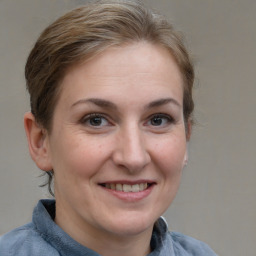 Joyful white adult female with short  brown hair and grey eyes