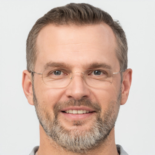 Joyful white adult male with short  brown hair and brown eyes