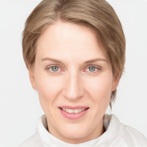 Joyful white adult female with medium  brown hair and grey eyes