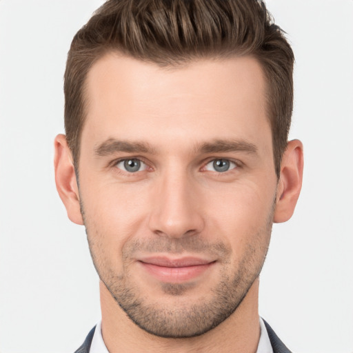 Joyful white young-adult male with short  brown hair and brown eyes