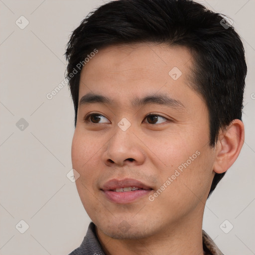 Joyful asian young-adult male with short  black hair and brown eyes