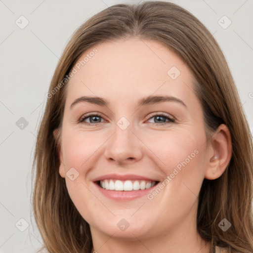 Joyful white young-adult female with long  brown hair and grey eyes