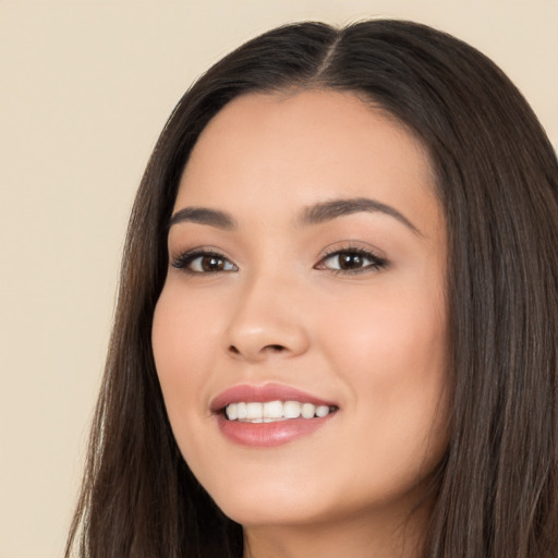 Joyful white young-adult female with long  black hair and brown eyes