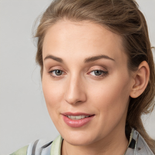 Joyful white young-adult female with medium  brown hair and grey eyes