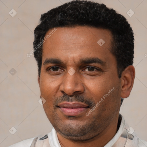 Joyful latino adult male with short  black hair and brown eyes