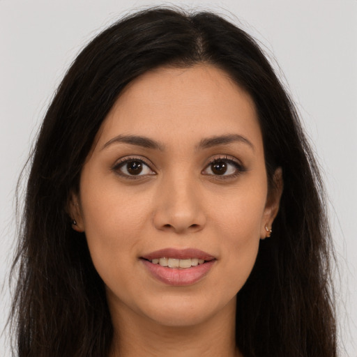 Joyful white young-adult female with long  brown hair and brown eyes