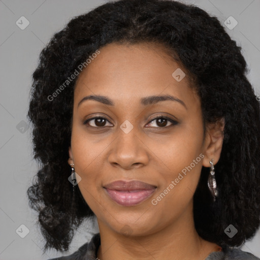 Joyful black young-adult female with long  brown hair and brown eyes