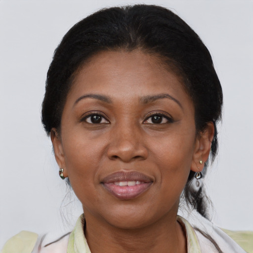 Joyful black adult female with medium  brown hair and brown eyes
