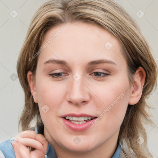 Joyful white young-adult female with medium  brown hair and blue eyes