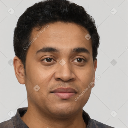 Joyful latino young-adult male with short  brown hair and brown eyes