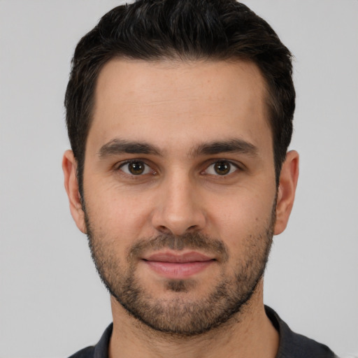 Joyful white young-adult male with short  brown hair and brown eyes