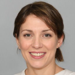 Joyful white young-adult female with medium  brown hair and brown eyes