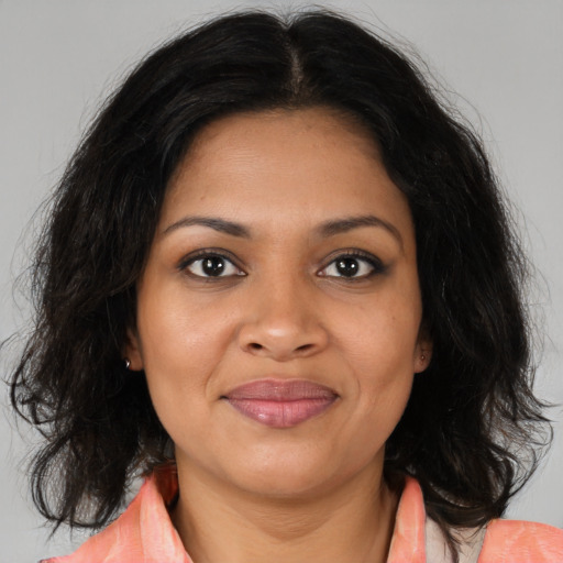 Joyful black young-adult female with medium  brown hair and brown eyes