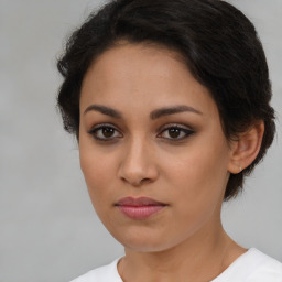 Joyful latino young-adult female with short  brown hair and brown eyes