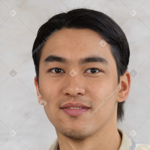 Joyful asian young-adult male with short  black hair and brown eyes