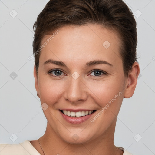 Joyful white young-adult female with short  brown hair and brown eyes