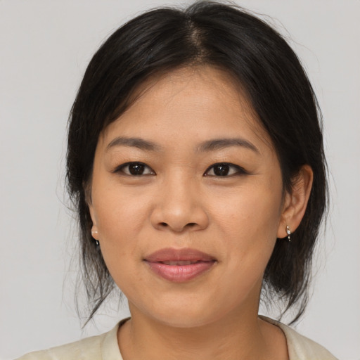 Joyful asian young-adult female with medium  brown hair and brown eyes
