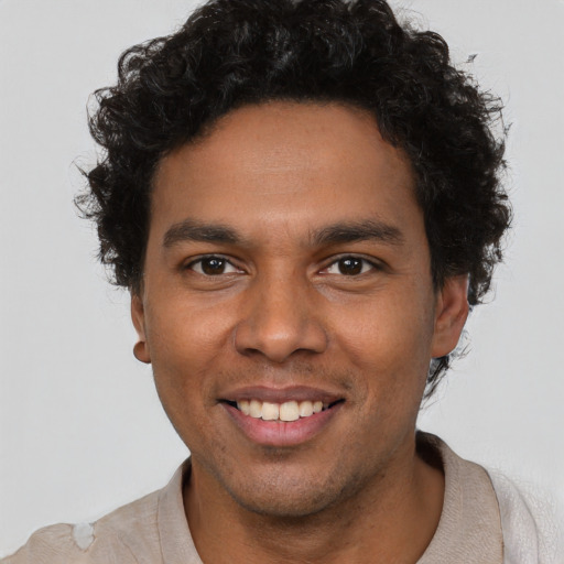 Joyful black young-adult male with short  brown hair and brown eyes