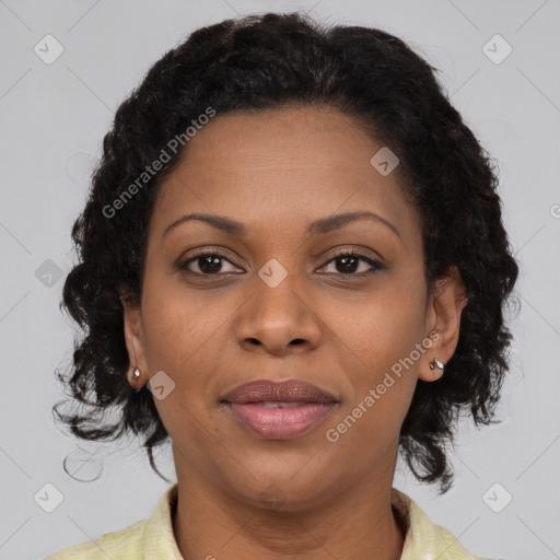 Joyful black adult female with medium  brown hair and brown eyes