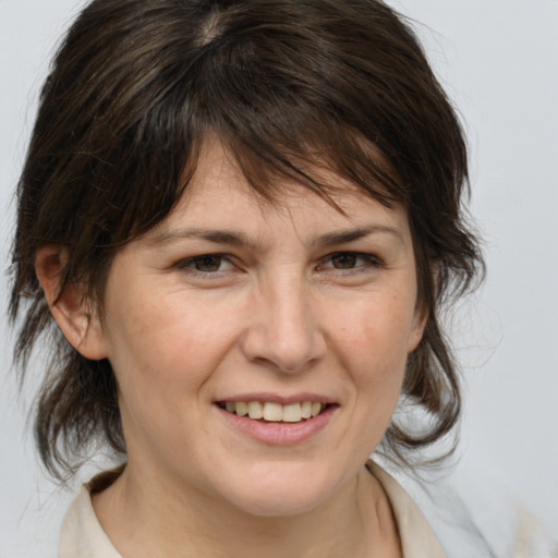 Joyful white adult female with medium  brown hair and brown eyes