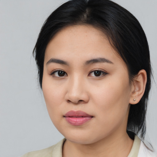 Joyful asian young-adult female with medium  brown hair and brown eyes