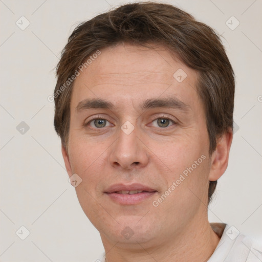 Joyful white adult male with short  brown hair and grey eyes