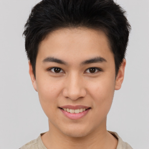 Joyful asian young-adult male with short  brown hair and brown eyes