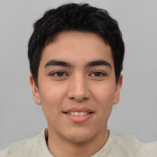 Joyful asian young-adult male with short  brown hair and brown eyes
