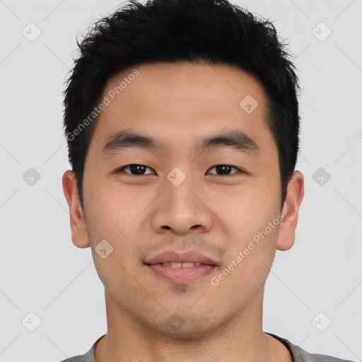 Joyful asian young-adult male with short  black hair and brown eyes