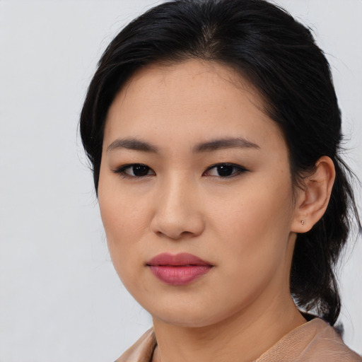 Joyful asian young-adult female with medium  brown hair and brown eyes
