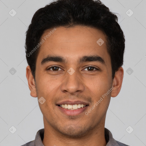 Joyful latino young-adult male with short  black hair and brown eyes