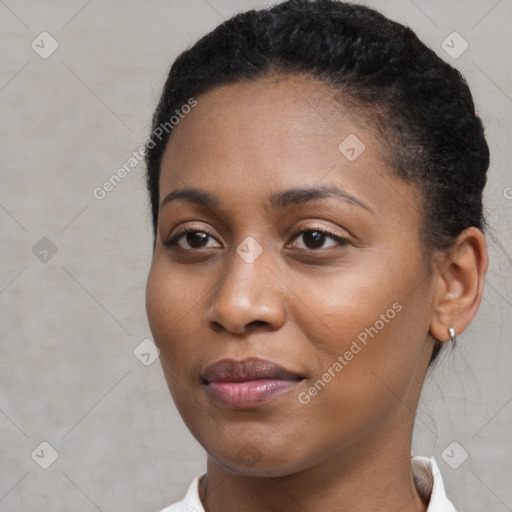 Joyful black young-adult female with short  brown hair and brown eyes