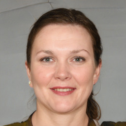 Joyful white adult female with medium  brown hair and grey eyes