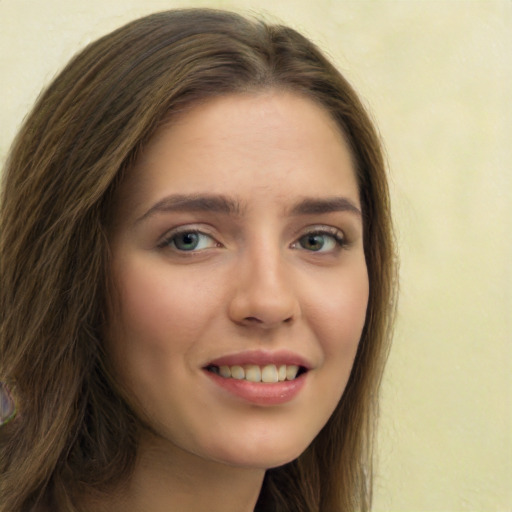 Joyful white young-adult female with long  brown hair and green eyes