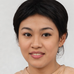 Joyful asian young-adult female with medium  black hair and brown eyes