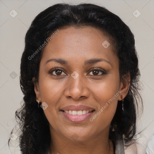 Joyful black adult female with long  brown hair and brown eyes