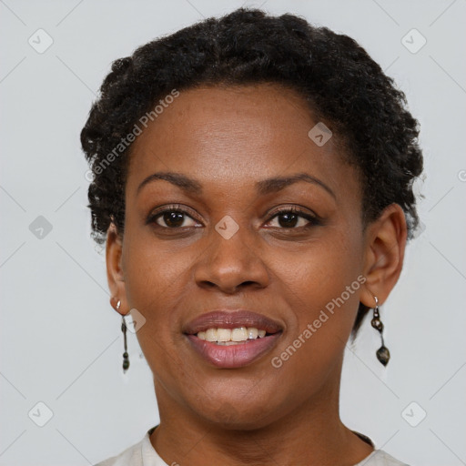 Joyful black young-adult female with short  brown hair and brown eyes