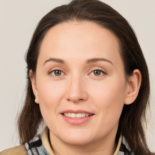 Joyful white young-adult female with medium  brown hair and brown eyes