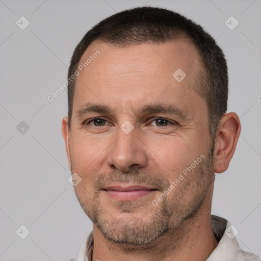 Joyful white adult male with short  brown hair and brown eyes