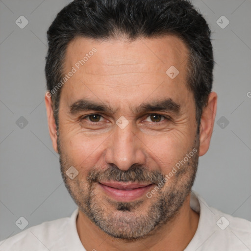 Joyful white adult male with short  black hair and brown eyes