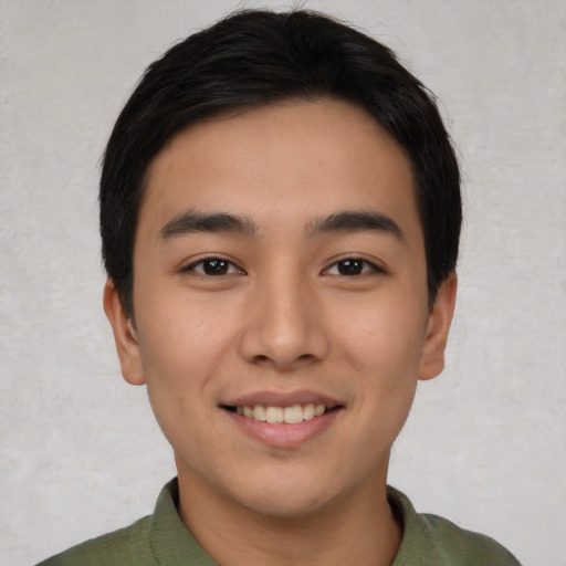 Joyful asian young-adult male with short  black hair and brown eyes