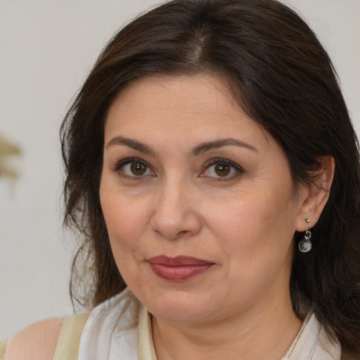 Joyful white adult female with medium  brown hair and brown eyes